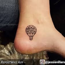 a small tattoo on the foot of a person with a hot air balloon in it