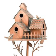 a metal bird house with two birds perched on it