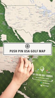 the push pin usa golf map is being held up by a person's hand