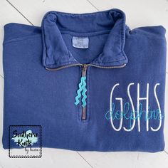 a blue shirt with the word ghsh on it and a zippered closure