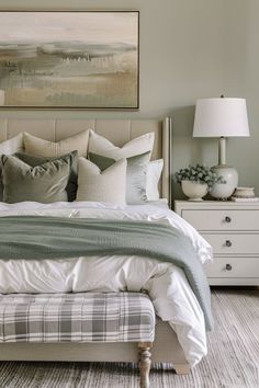 a bedroom with a bed, nightstands and painting on the wall above it's headboard