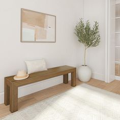 a wooden bench sitting on top of a hard wood floor next to a potted plant