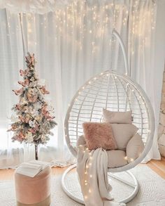 a living room with a christmas tree in the corner and a chair next to it