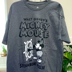 Never Worn! Men’s Walt Disney Mickey Mouse In Steamboat Willie Dark Grey Tshirt. From The Disney Parks. Price Tag Was Removed But Still Plastic Tag On The Side. Could Use A Good Iron. It’s Been Sitting In My Husbands Closet. Never Wore It On Our Last Trip. Comes From A Smoke Free Home. Mickey Mouse Shirt, Grey Tshirt, Walt Disney Mickey Mouse, Best Iron, Steamboat Willie, Mickey Mouse Shirts, Disney Shirts, Disney Mickey Mouse, Price Tag