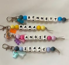 three keychains with letters that spell out names