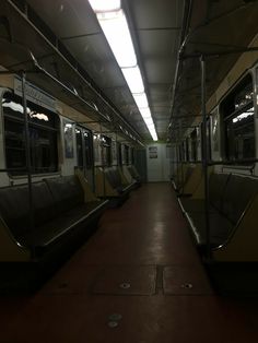 an empty subway car with no people on the platform or in the station, at night