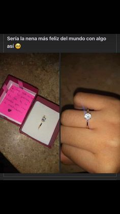 a person's hand holding an open ring with a note in it and a pink box on the ground