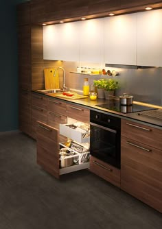 an open drawer in the middle of a kitchen