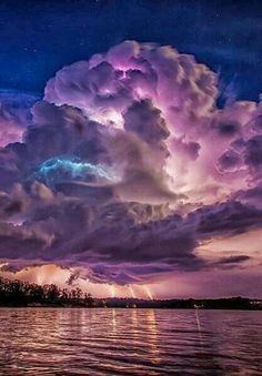 the sky is filled with purple clouds and lightning