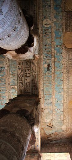 an ancient room with egyptian writing on the walls and columns in the ceiling, as well as two large vases