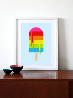 an ice cream popsicle is in front of a wall with a bowl on it