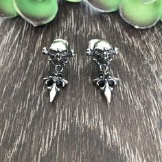 Artfully crafted Skull and Cross studs earrings are made of Stainless steel . Skull has 3-D look and it is hallow inside, which makes them pretty light. Those studs are gender neutral and perfect for men, women and kids. -Size is around 1 inch long from edge to edge -All items are shipped in a gift box Gothic Pierced Jewelry For Streetwear, Punk Surgical Steel Pierced Earrings, Gothic Metal Earrings For Streetwear, Black Gothic Earrings With Skull Print, Edgy Skull-shaped Pierced Earrings, Silver Metal Emo Earrings, Silver Metal Emo Style Earrings, Gothic Silver Earrings For Streetwear, Gothic Skull Shaped Pierced Earrings