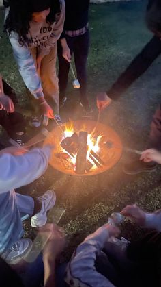 a group of people sitting around a fire pit