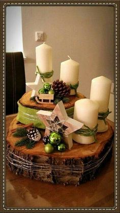 a wooden table topped with candles and ornaments