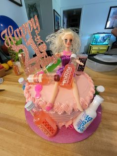 a birthday cake with a barbie doll on top