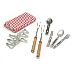 an assortment of kitchen utensils are laid out on a white tablecloth with a red and white checkered napkin