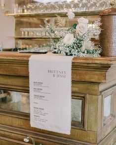 a table with flowers and menu on it