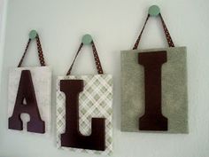 three wall hangings with the letters i, j, and l on each side