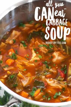 a pot filled with cabbage soup on top of a table