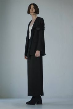 Elegant and luxurious midi skirt. Complemented by a diagonal seam and a deep neckline on the back. It elongates the silhouette beautifully. Looks great goes well with the Aubrey jacket, made of the same material as the drapery on it. Elegant Black Skirt Suit For Evening, Elegant Evening Blazer With Structured Boning, Elegant Evening Blazer With Structured Shoulders, Elegant Asymmetrical Blazer For Party, Elegant Asymmetrical Blazer For Spring, Elegant Asymmetrical Spring Blazer, Elegant Fall Skirt Suit For Night Out, Elegant Evening Skirt Suit For Fall, Evening Blazer With Structured Shoulders