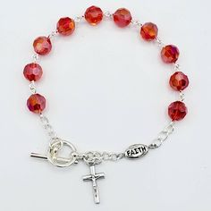 "This handmade rosary bracelet is made with 8mm siam red Chinese crystal beads and an 8mm silver plated \"FAITH\" Our Father bead featuring a 0.5\" cross charm. All findings are silver plated. All rosary parts are made in Italy. This bracelet is 7.5 inches long. Please choose a Patron Saint Medal to add to your bracelet! (included Each bracelet in my shop is handmade by yours truly. And I back all of my work with a 100% satisfaction guarantee. If you are not completely satisfied, please contact Handmade Rosary, Our Father, Rosary Bracelet, Saints Medals, Prayer Warrior, Patron Saints, Have A Blessed Day, Drawstring Pouch, Cross Charms