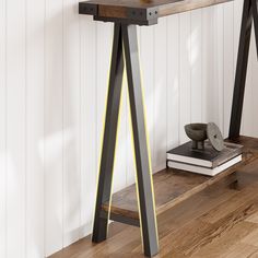 a wooden table sitting on top of a hard wood floor next to a book shelf