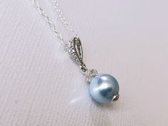 Wedding Swarovski 8mm Light Blue Pearl Drop Pendant with .925 Sterling Silver Chain Bridal Necklace. CHAIN is 18 inches (45.7cm) long. PENDANT is about 0.75 inch (2cm) long including bail. Elegant and timeless, this dainty necklace is perfect for weddings or special occasions such as birthdays, anniversaries, graduations, proms...or whatever you can imagine! Handmade necklace, is made with .925 Sterling Silver 18 inches cable chain, Swarovski 8mm Light Blue round crystal pearl, Rhodium Sterling Elegant Light Blue Round Pendant Necklace, Sapphire Round Pendant Jewelry For Wedding, Sapphire Round Pendant For Wedding, Elegant Light Blue Necklace For Anniversary, Blue Round Pendant Jewelry For Wedding, Blue Pearl Pendant Jewelry, Blue Pendant Jewelry With Pearl, Blue Pearl Pendant Jewelry For Wedding, Formal Blue Necklace With Pearl Pendant