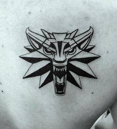 a black and white image of a wolf head on the back of a man's shoulder