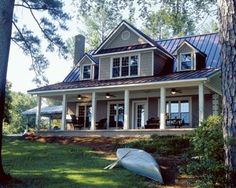 a boat sitting on the grass in front of a house with a porch and wrapper