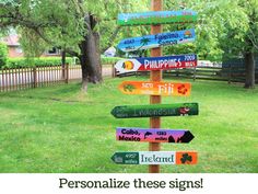 a wooden sign post with many different colored signs on it's side in the grass