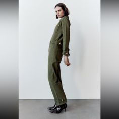 Long Lapel Collar Jumpsuit With Long Cuffed Sleeves. Patch Pockets With Zipper. Belted Detail At Waistband And Cuffs. Front Metal Zip Closure. Outer Shell 100 % Zara Jumpsuits And Rompers For Spring Workwear, Chic Zara Overalls For Spring, Trendy Zara Jumpsuits And Rompers Overall, Green Utility Style Jumpsuit For Work, Green Utility Jumpsuits And Rompers For Work, Zara Denim Overall Jumpsuit For Work, Chic Denim Overall Jumpsuit For Work, Chic Fall Overalls For Workwear, Spring Workwear Overalls