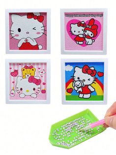 four hello kitty magnets are being held by a person's hand with a pink pen