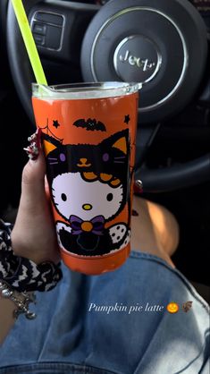 a person holding up a cup with a cat on it