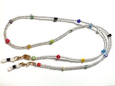 This is a very pretty chain with lots of colour to match any outfit. I have mixed silver lined clear glass beads with a variety of Millefiori glass flower beads on leather cord to make a unique cord.   The cord is clamped firmly and I've put small gold lobster clasps at each end holding the silicone grips. 💚 Each chain comes with a spare set of silicone grips. This chain measures 79cm from grip end to grip end. I hope you like my handmade items and thank you for looking :) Flowers Accessories, Glasses Chains, Cute Glasses, Sunglass Chain, Eyeglass Chain, New Glasses, Silver Line, Glasses Chain, Flower Beads