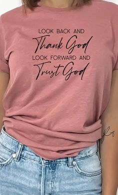 Look back and Thank God look forward and Trust God Inspirational Graphic Tee. Most t-shirt colors are 52/48 cotton/polyester blend. Athletic Heather is 90/10 cotton/polyester. White, cream and canvas red are 100% cotton. Ash is 99/1 cotton/polyester. Inspirational Graphic Tees, Heather Brown, Pink Canvas, Christian Tees, Christian Clothing, Christian Shirts, Thank God, Heather Black, Christian Gifts