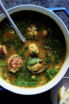 a bowl of soup with spinach and cauliflower