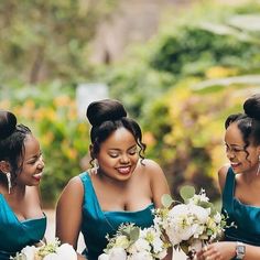 three bridesmaids in blue dresses holding bouquets and smiling at each other while sitting down