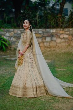 a woman in a white and gold bridal gown