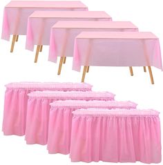 six pink tablecloths with wooden legs and one white table cloth on the top