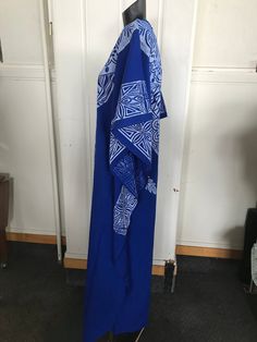 "A screen printed caftan tailored bu Indian Tailors in Fiji prior to 1972.Blue with white overprint which include Pacifica motifs.It is unworn. Fabulous symmetrical graphics which include a reference to Fiji Islands, It's label size is 32 which is to suit a 32\"bust. No faults. Still has original fold marks. These are the measurements, :- Bust 38\" Length from shoulder seam to hem 51\" Unstitched at sides for 21\" to allow ease of walking Overall width 38\" ( each side)" Floor-length Maxi Dress With Traditional Patterns For Festivals, Traditional Patterned Festival Maxi Kaftan, Traditional Pattern Maxi Kaftan For Festivals, Traditional Pattern Maxi Length Kaftan For Festivals, Traditional Maxi Kaftan For Festivals, Long Bohemian Batik Print Dress, Bohemian Floor-length Dress With Traditional Patterns, Printed Floor-length Maxi Dress For Festivals, Long Printed Hippie Dresses