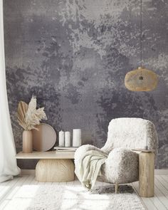 a white chair sitting in front of a window next to a table with candles on it