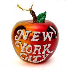 a glass apple with the words new york city painted on it's front and side