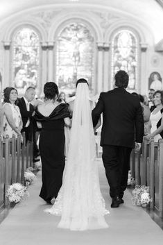 the bride and groom are walking down the aisle