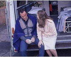 a man and woman sitting in the back of a van