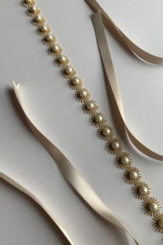 Pearl Cora | Bridal belts | Hushed Commotion Elegant Gold Sashes With Embroidered Belt, Elegant Adjustable Beige Belt, Elegant Cream Sashes For Formal Occasions, Elegant Adjustable Gold Belt, Elegant Adjustable Embroidered Belt, Elegant Gold Belt With Sashes, Elegant Pearl Embellished Sashes For Party, Gold Sash Belts For Formal Occasions, Elegant Formal Embroidered Belt Sash