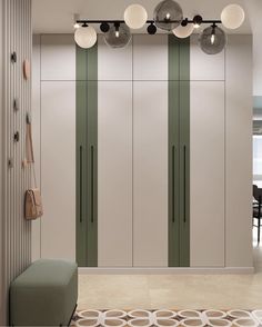 an empty room with green and white stripes on the wall, lights above it and a bench in front