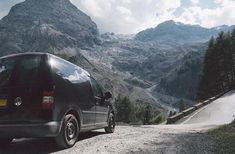 a van parked on the side of a mountain road