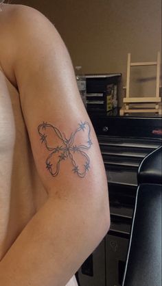 a woman with a butterfly tattoo on her arm