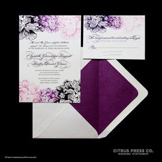 the purple and white wedding stationery is set on top of an envelope with matching paper