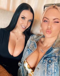 two women are posing for the camera with their mouths open and one is showing off her large breast